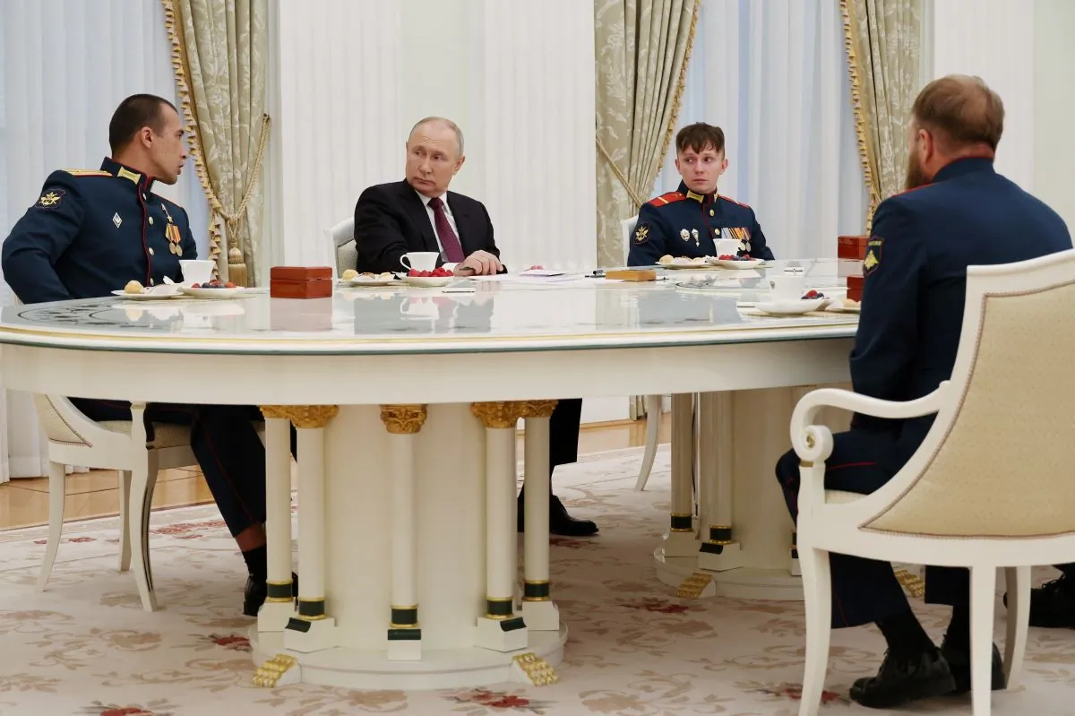 Russian President Vladimir Putin meets with the crew of the Alyosha T-80 tank, which destroyed a Ukrainian armoured convoy on the Zaporizhzhia direction in the course of Russia-Ukraine conflict, at the Kremlin in Moscow, Russia, on Aug. 24, 2023. (Mikhail Klimentyev/Sputnik/Kremlin via Reuters)
