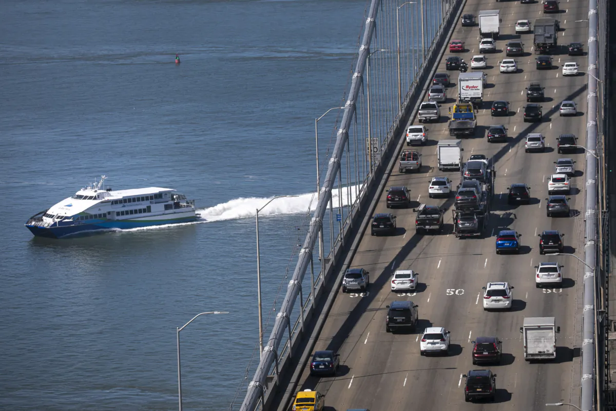 A San Francisco Bay Ferry cruises under rush-hour traffic on the San Francisco-Oakland Bay Bridge. (Karl Mondon/Bay Area News Group/TNS)