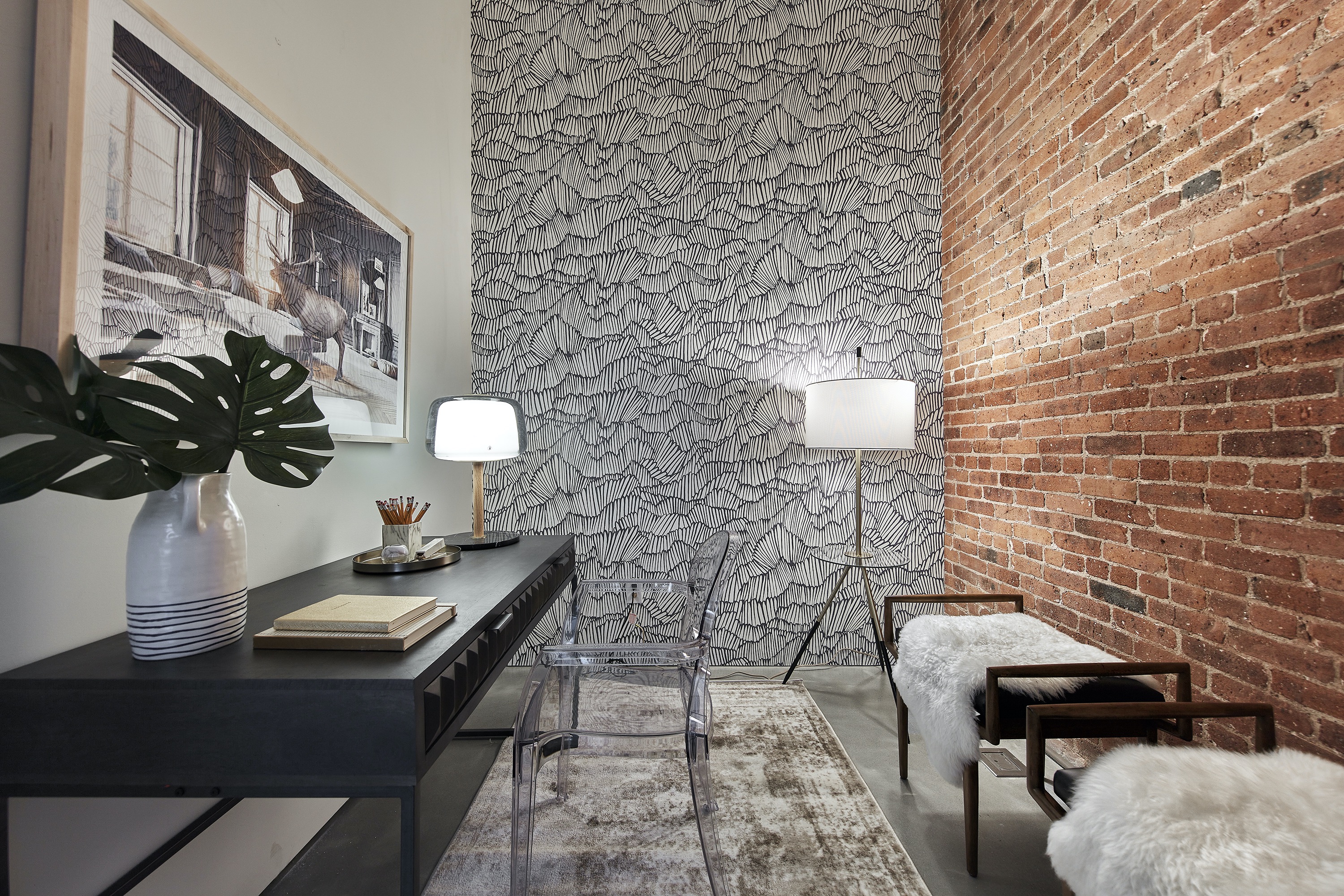 A windowless room is made functional as a home office/workspace.
