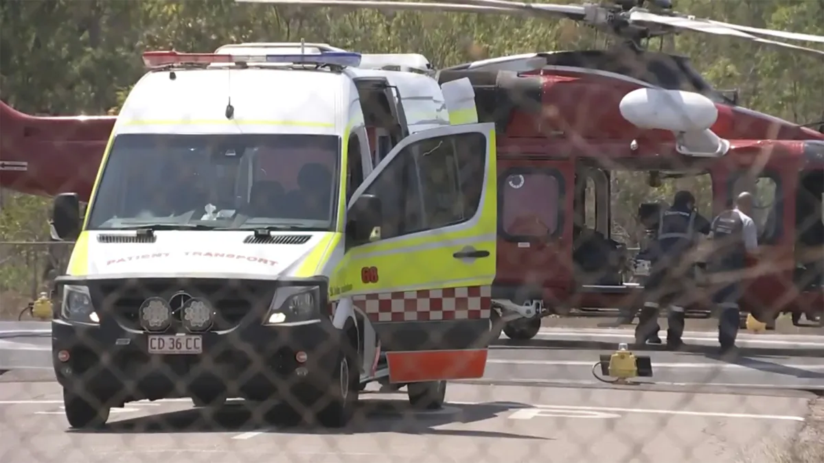 A helicopter and ambulance involved in rescue mission, following an aircraft crash, in Darwin, Australia, on Aug. 27, 2023. (AuBC via AP)