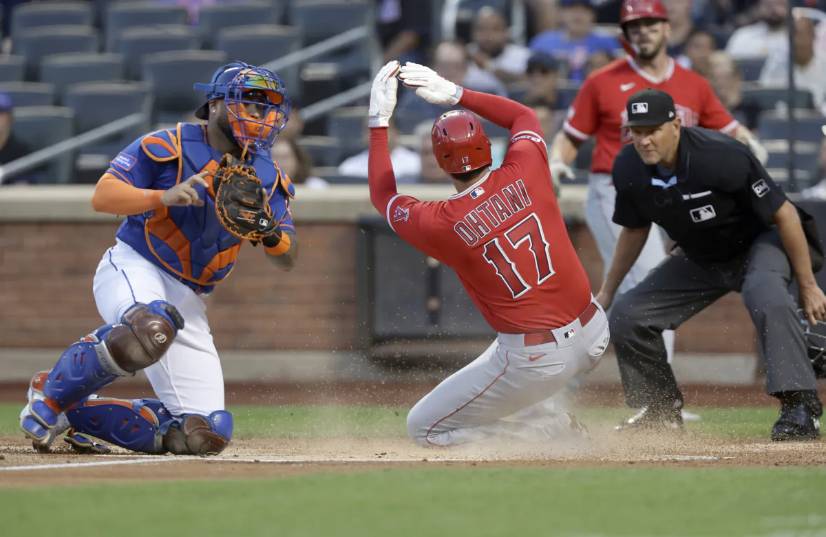 Shohei Ohtani (17) of the Los Angeles Angels beats the tag attempt from Omar Narvaez (2) of the New York Mets to score a run during the first inning at Citi Field in New York City on August 26, 2023. (Jim McIsaac/Getty Images)