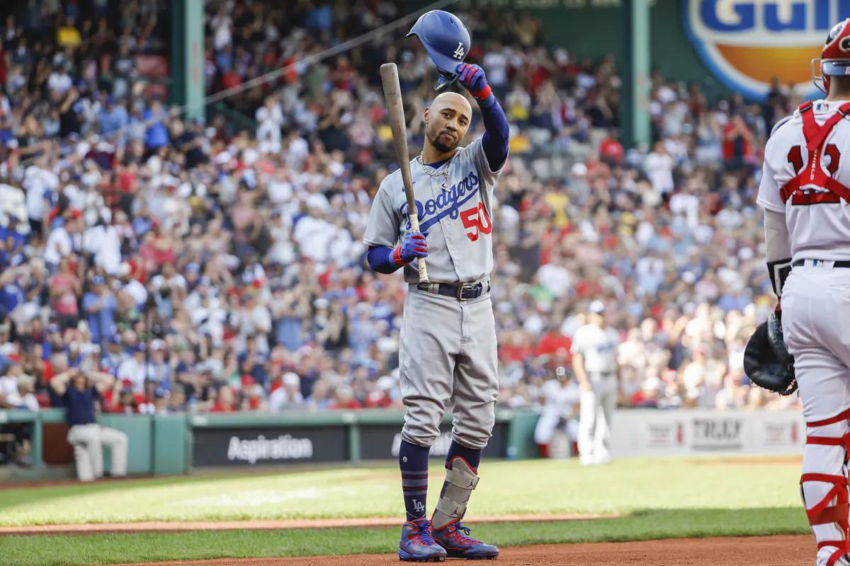 Mookie Betts (50) of the Los Angeles Dodgers tips his helmet to fans before his first at-bat against his former team, the Boston Red Sox, during the first inning at Fenway Park in Boston on Aug. 26, 2023. (Winslow Townson/Getty Images)