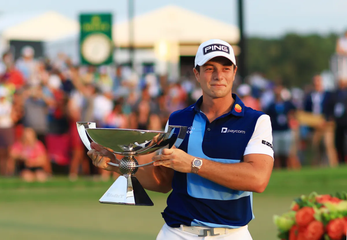 Viktor Hovland of Norway celebrates with the FedEx Cup after winning during the final round of the TOUR Championship at East Lake Golf Club in Atlanta, Georgia, on Aug. 27, 2023. (Mike Ehrmann/Getty Images)