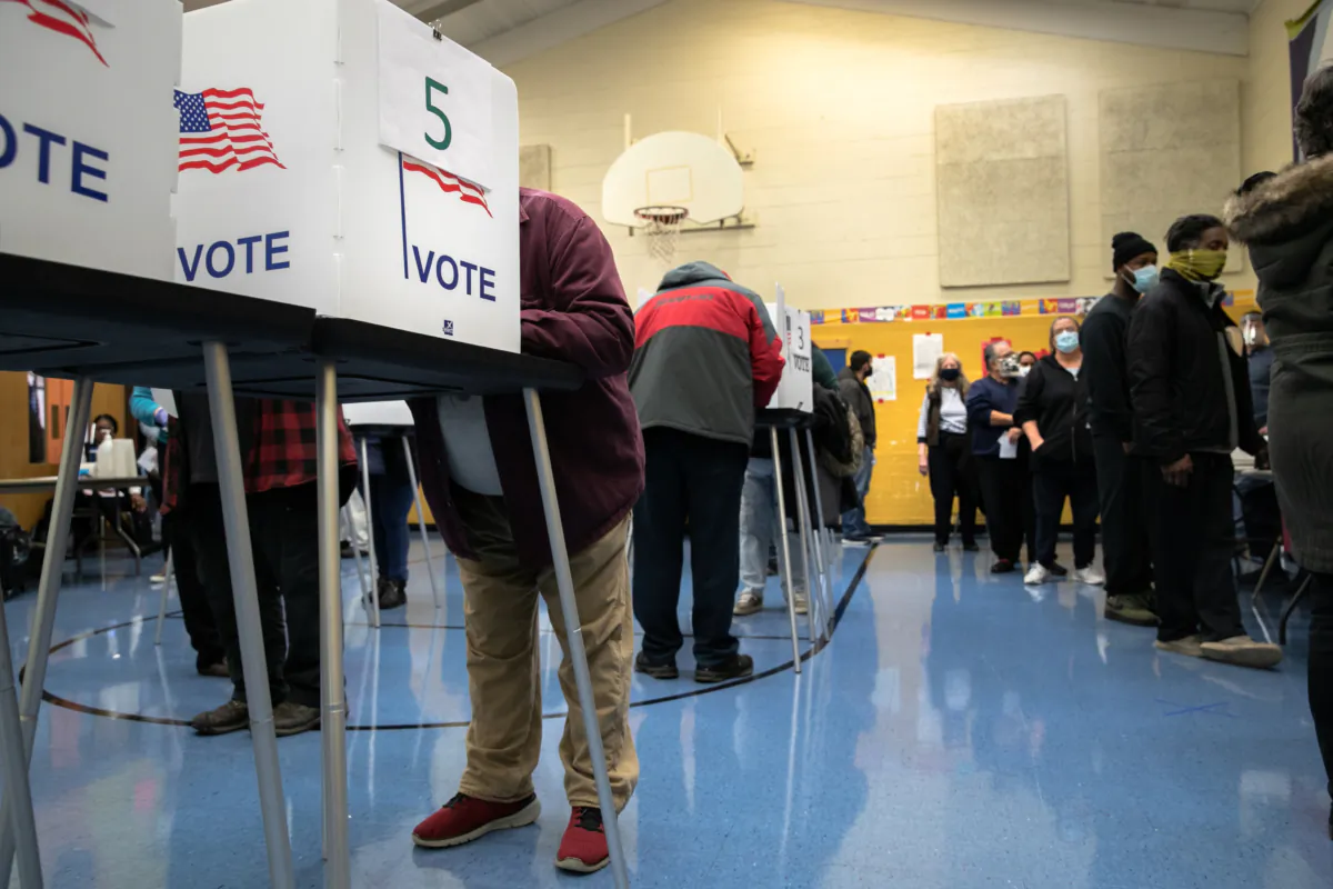 Voters fill out their ballots at a school gymnasium in Lansing, Michigan, on Nov. 3, 2020. (John Moore/Getty Images)