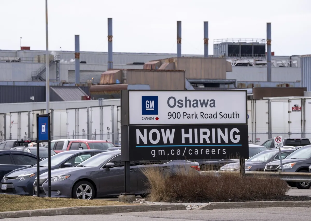 A sign announcing hiring is shown at the General Motors facility in Oshawa, Ontario on April 4, 2022 (The Canadian Press/Frank Gunn)
