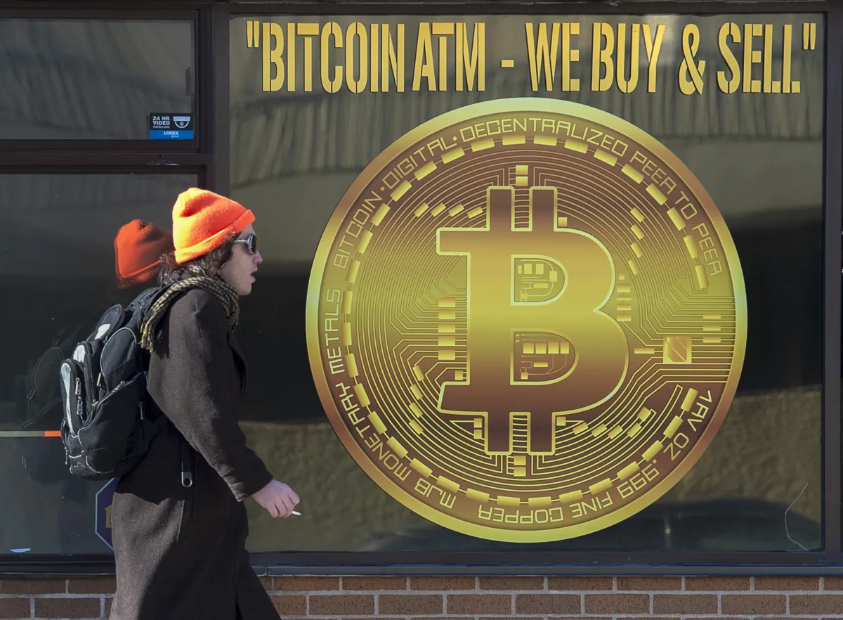 A sign advertises a Bitcoin automated teller machine, ATM, at a shop in Halifax on Feb. 4, 2020. (The Canadian Press/Andrew Vaughan)