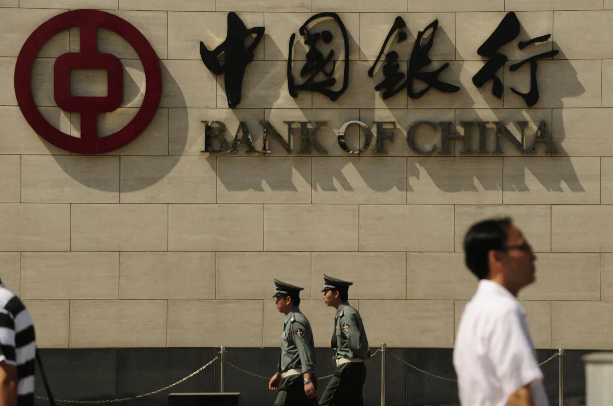 People walk past a branch of the Bank of China in Beijing on Sept. 11, 2009. (Peter Parks/AFP via Getty Images)