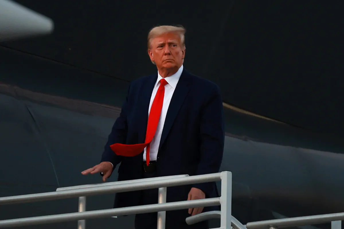 Former President Donald Trump boards his private airplane, also known as Trump Force One, as he departs Atlanta Hartsfield-Jackson International Airport after being booked at the Fulton County jail in Atlanta on Aug. 24, 2023. (Joe Raedle/Getty Images)