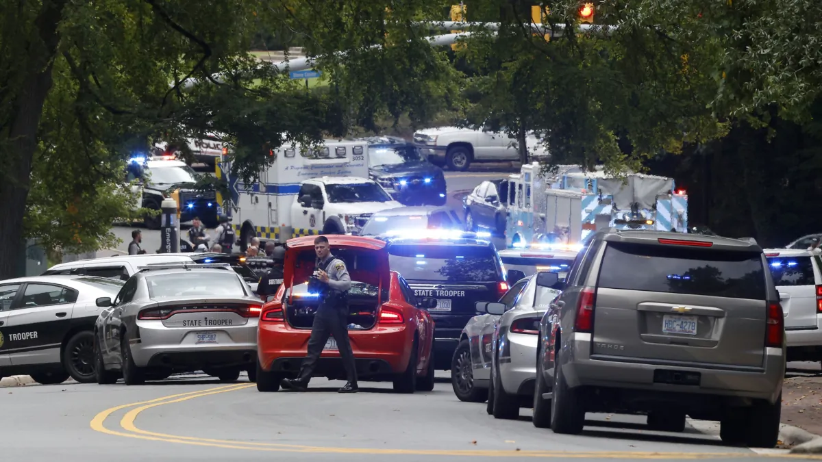 Law enforcement and first responders gather on South Street near the Bell Tower on the University of North Carolina at Chapel Hill campus in Chapel Hill, N.C., on Aug. 28, 2023, after a report of an "armed and dangerous person" on campus. (Kaitlin McKeown/The News & Observer via AP)