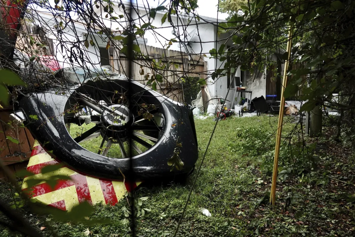 The tail rotor of a Broward Sheriff's Office Fire-Rescue helicopter in the backyard of a home after crashing, near Fort Lauderdale. Fla., on Aug. 28, 2023. (Joe Cavaretta/South Florida Sun-Sentinel via AP)