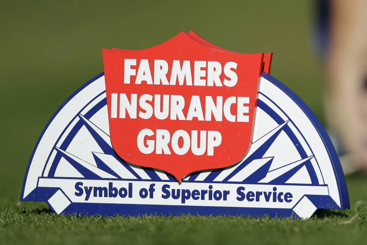 The logo for the Farmers Insurance Group is seen on the North Course during the first round of the Farmers Insurance Open golf tournament, Jan. 26, 2012, in San Diego. Farmers Insurance will lay off 11% of its workforce—or about 2,400 employees—as part of restructuring efforts, the company announced Monday, Aug. 28, 2023. (AP Photo/Gregory Bull)