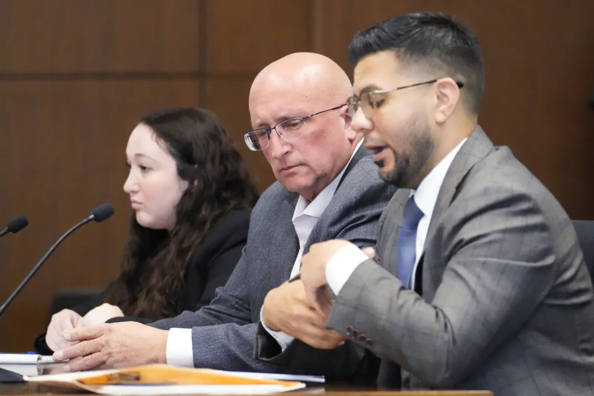 Attorney George Gomez (R) speaks as attorney Alanna Myerson (L) and Robert E. Crimo Jr. (C) listen during an appearance at the Lake County Courthouse in Waukegan, Ill., on Aug. 28, 2023. (Nam Y. Huh/Pool via AP Photo)