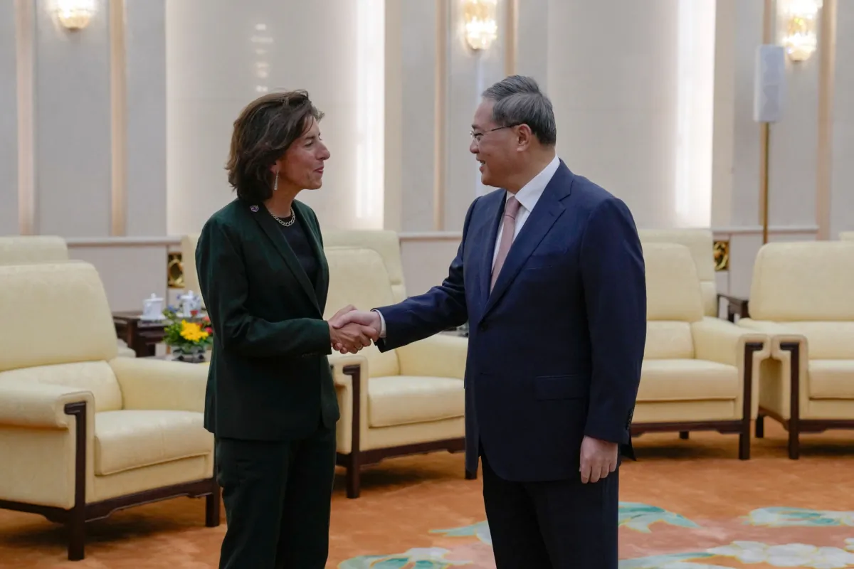 China's Premier Li Qiang greets U.S. Commerce Secretary Gina Raimondo at the Great Hall of the People in Beijing on Aug. 29, 2023. (Andy Wong/Pool/AFP via Getty Images)