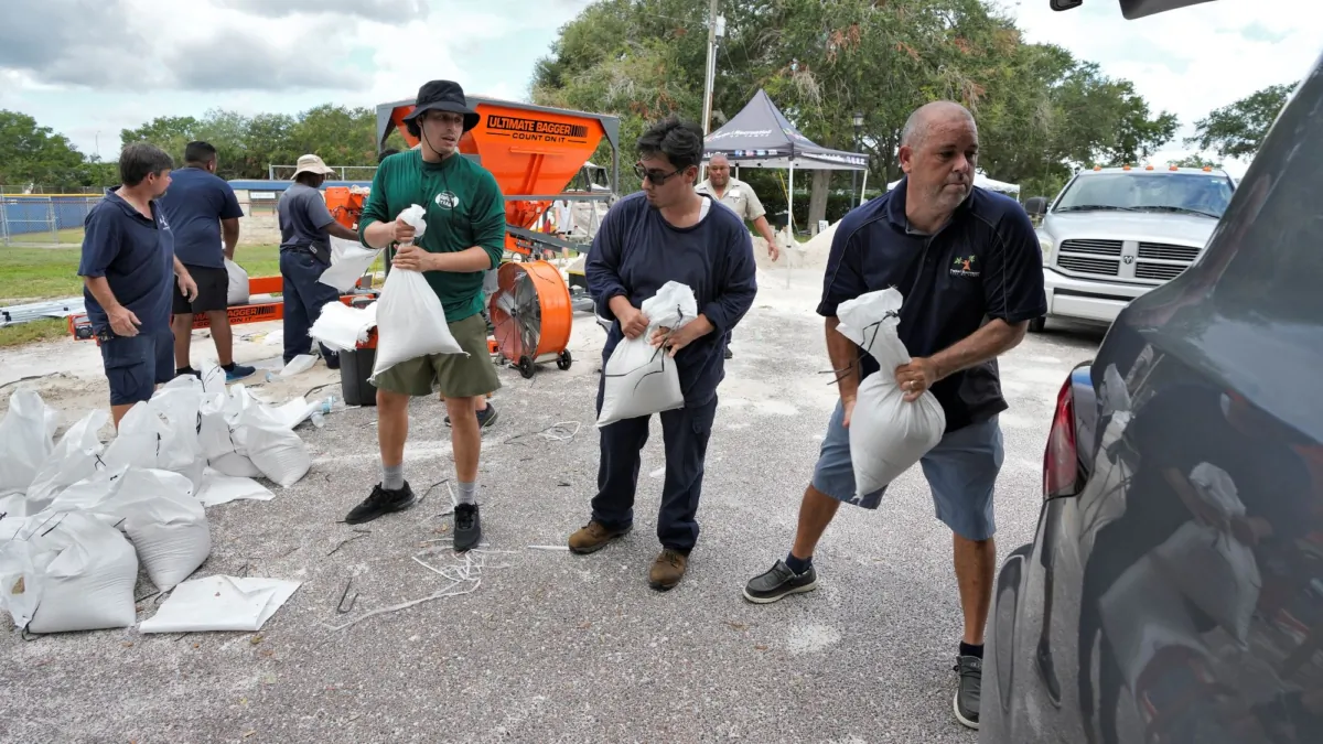Members of the Tampa, Fla., Parks and Recreation Department help residents load sandbags in Tampa, Fla., on Aug. 28, 2023. (Chris O'Meara/AP Photo)
