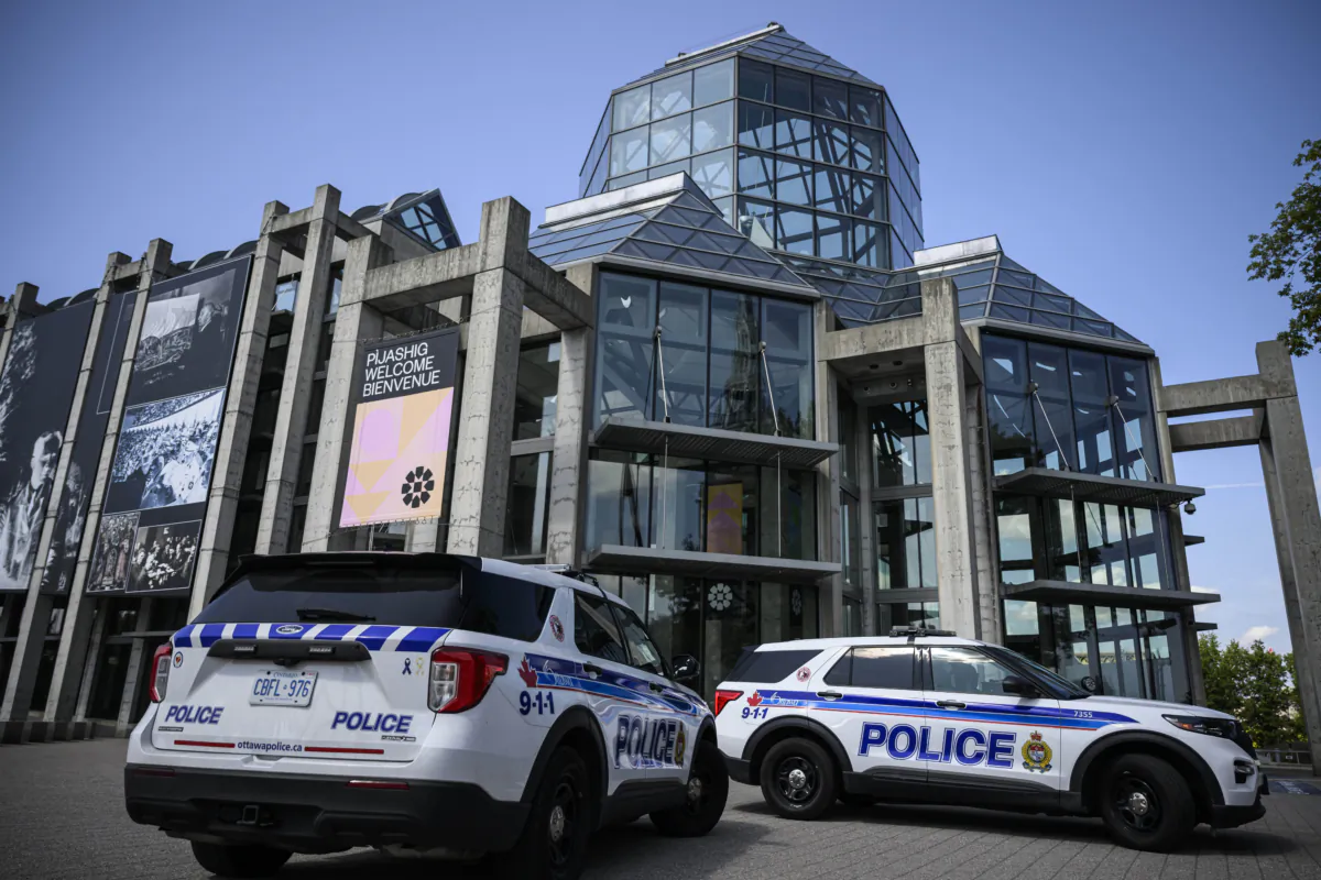 Ottawa Police attend the National Gallery of Canada, where a climate activist threw paint on artist Tom Thomson's Northern River painting, at the National Gallery of Canada in Ottawa, on Aug. 29, 2023. Climate advocacy group On2Ottawa announced one of their supporters threw paint on the work of art to demand that the government respond to the wildfire crisis. (Justin Tang/The Canadian Press)