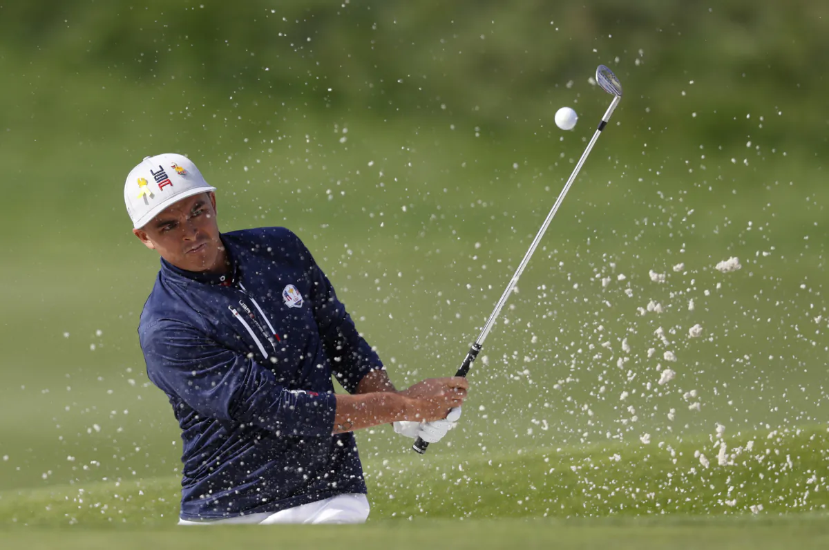 Rickie Fowler, of the U.S., plays out of a bunker on the 10th during a foursome match on the opening day of the 42nd Ryder Cup at Le Golf National in Saint-Quentin-en-Yvelines, outside Paris on Sept. 28, 2018. (Alastair Grant/AP Photo)