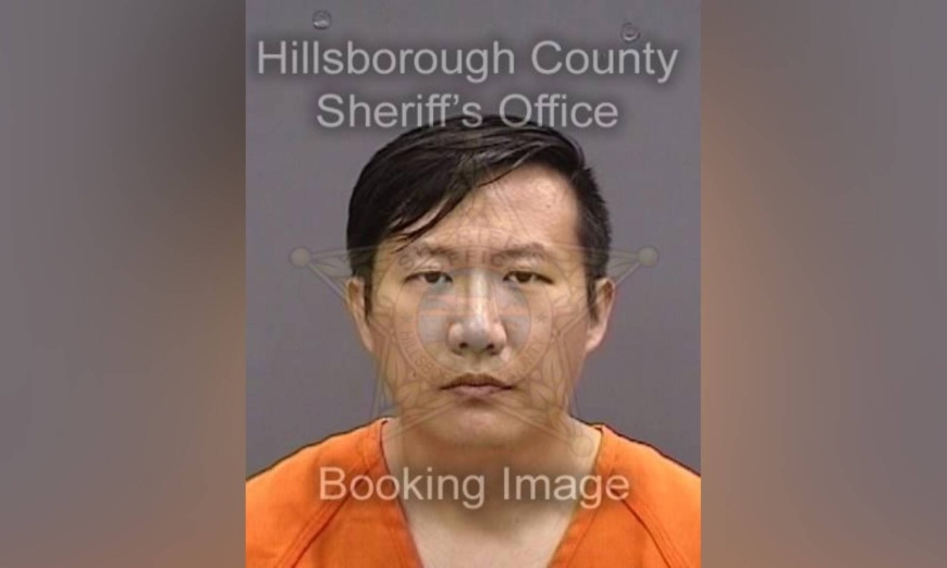 Florida Man Xuming Li caught on camera allegedly injecting chemical poison under neighbor’s door.
