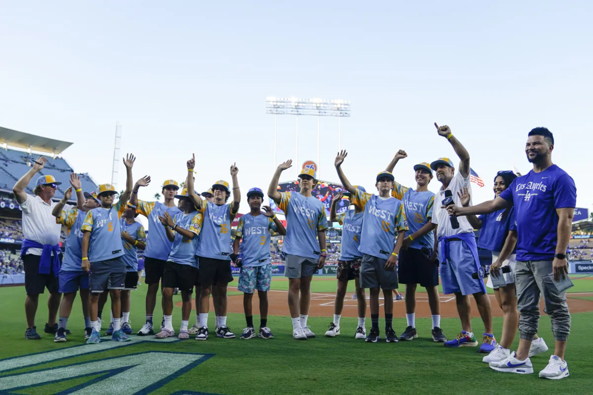El Segundo players wave during a ceremony honoring the team's victory in the Little League World Series, before a baseball game between the Los Angeles Dodgers and the Arizona Diamondbacks in Los Angeles on Aug. 29, 2023. (Ryan Sun/AP Photo)