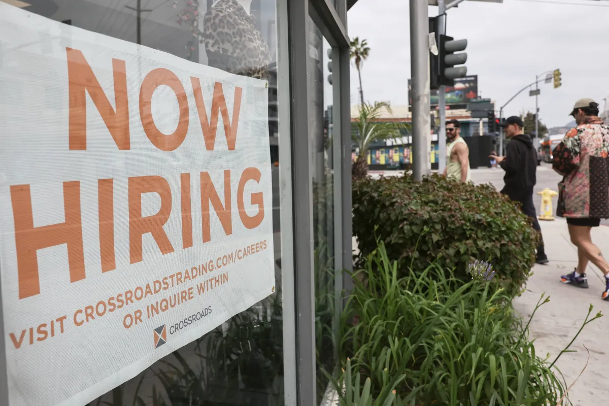 A Now Hiring sign is displayed outside a resale clothing shop in Los Angeles, California, on June 2, 2023. (Mario Tama/Getty Images)
