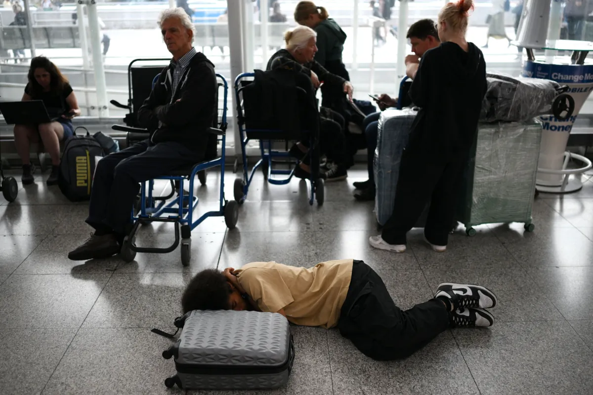 Passengers wait at Stansted Airport, north of London, after UK flights were delayed over a technical issue, on Aug. 29, 2023. (Daniel Leal/AFP via Getty Images)