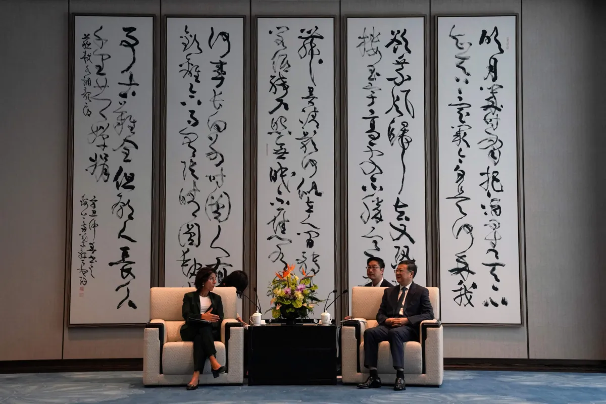 U.S. Commerce Secretary Gina Raimondo talks with Shanghai Party Secretary Chen Jining during a meeting in Shanghai on Aug. 30, 2023. (Andy Wong/Pool/AFP via Getty Images)