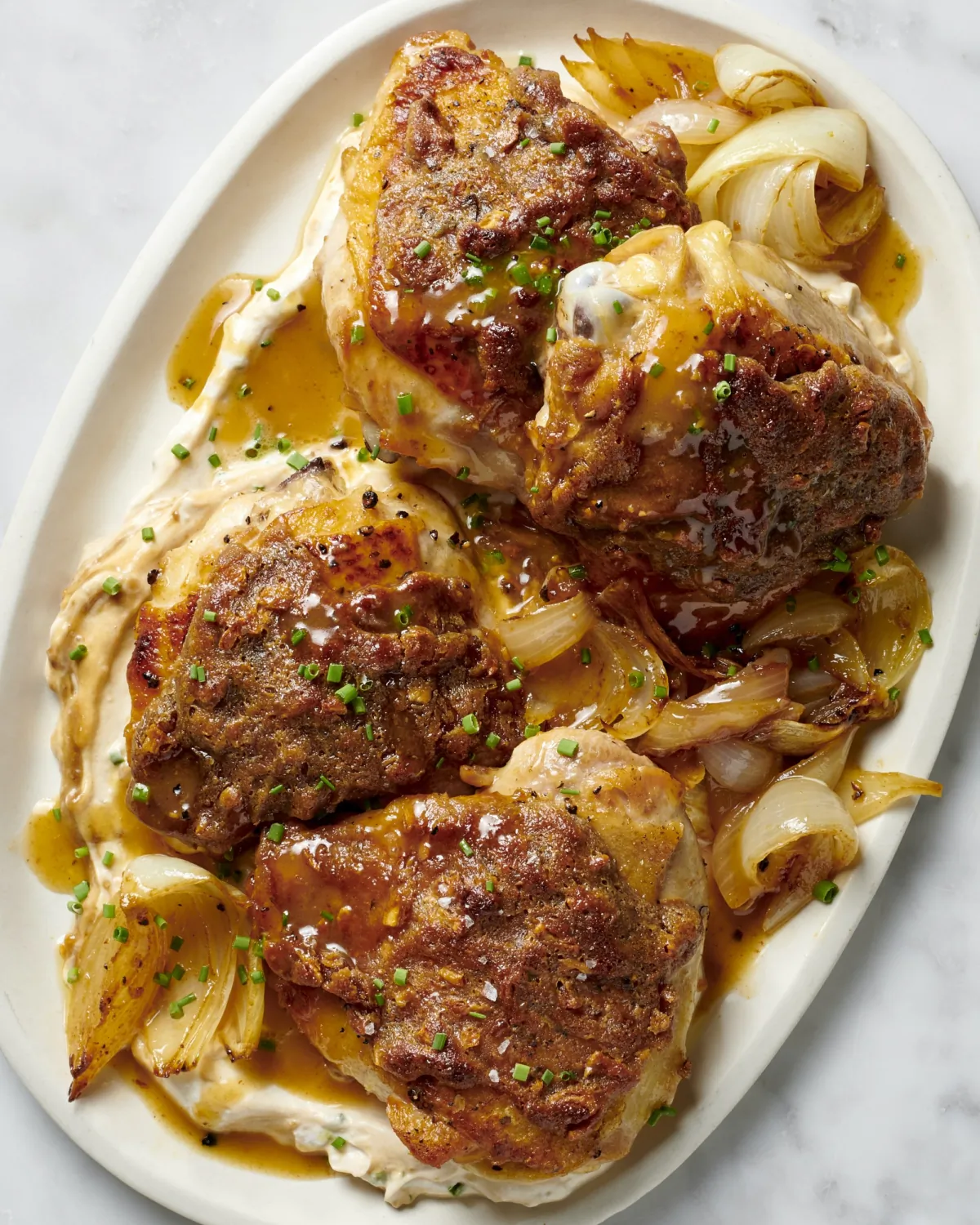 Rub skin-on chicken thighs in a combination of mayonnaise and onion soup mix for a simple chicken dinner full of crunch and tangy flavor.