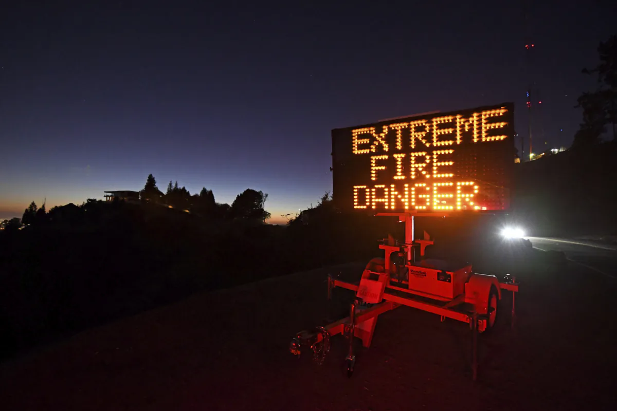 A roadside sign warns motorists of extreme fire danger on Grizzly Peak Boulevard, in Oakland, Calif., on Oct. 25, 2020. (Jose Carlos Fajardo/Bay Area News Group via AP)