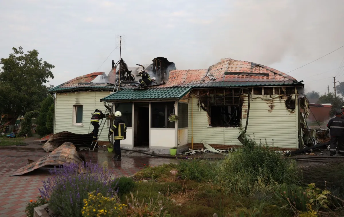 Firefighters extinguish a fire in a house that was damaged following a missile attack in a village outside Kyiv on Aug. 30, 2023. (Anatolii Stepanov/AFP via Getty Images)