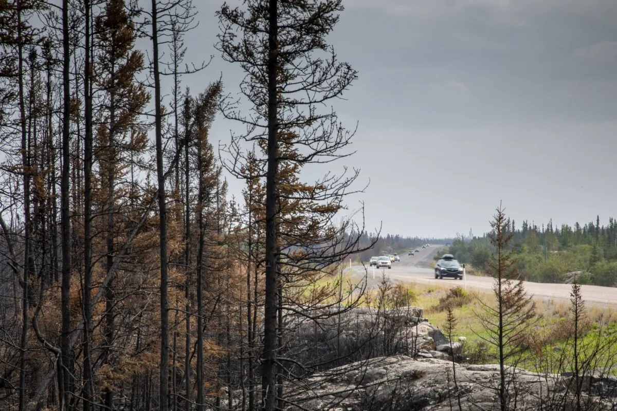 Evacuees from Yellowknife make their way along highway 3 on their way into Ft. Providence, Aug. 17, 2023. (The Canadian Press/Bill Braden)