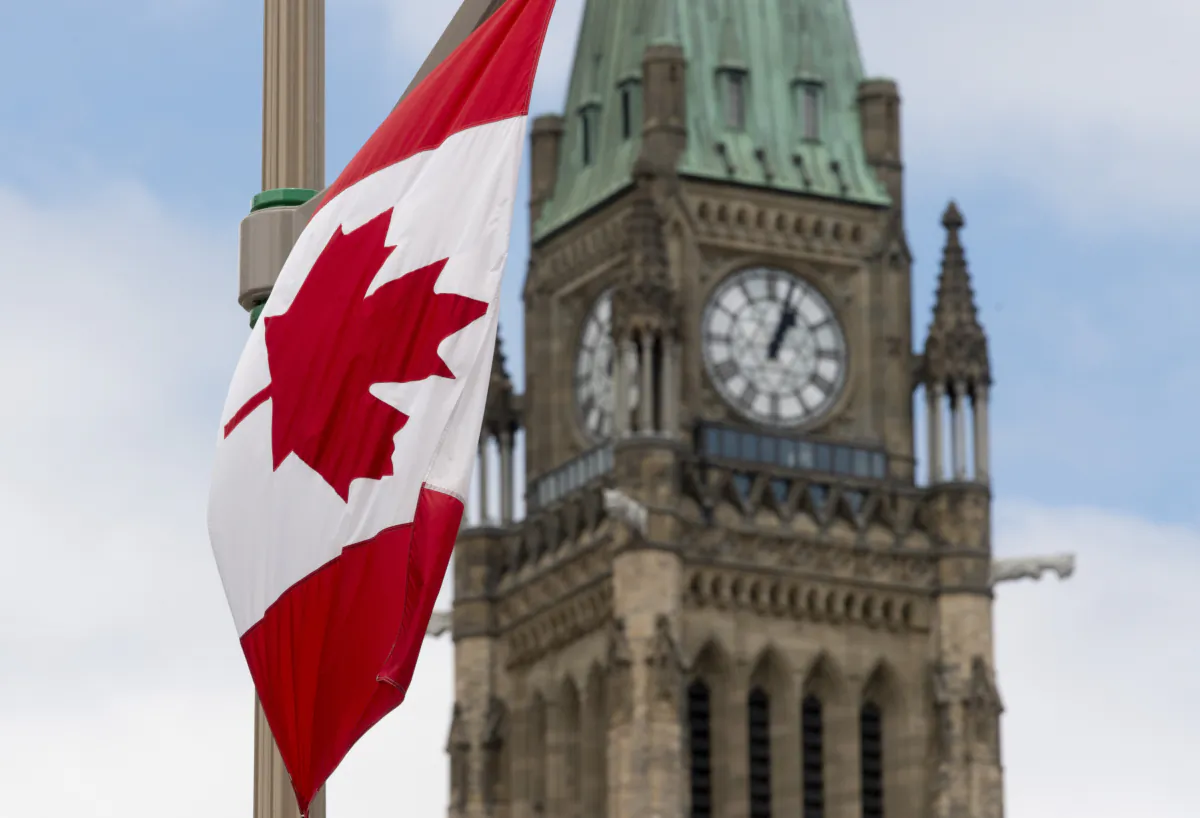 A Canadian flag hangs from a lamppost along the road in front of the Parliament buildings ahead of Canada Day, in Ottawa on June 30, 2020. (The Canadian Press/Adrian Wyld)