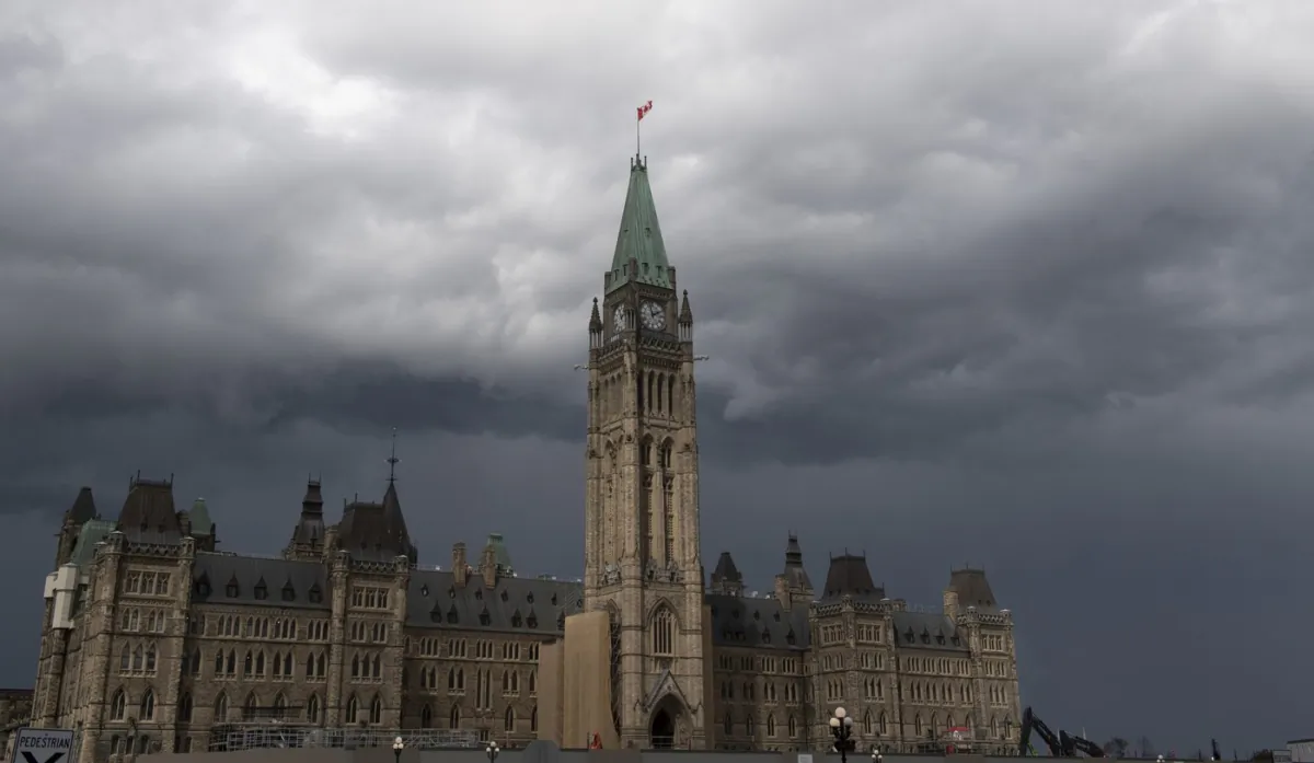 Storm clouds pass by the Peace Tower and Parliament Hill in Ottawa on Aug. 18, 2020. (The Canadian Press/Adrian Wyld)