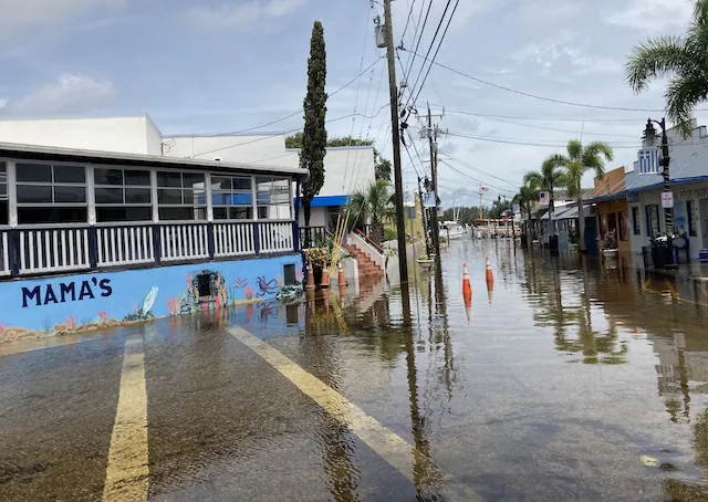 The intersection of Cross and Athens streets off Dodecanese Boulevard in Tarpon Springs, Fla., was still flooded around noon on Aug. 29, 2023, more than 12 hours after Hurricane Idalia churned past 125 miles to the west the night before. (John Haughey/The Epoch Times)