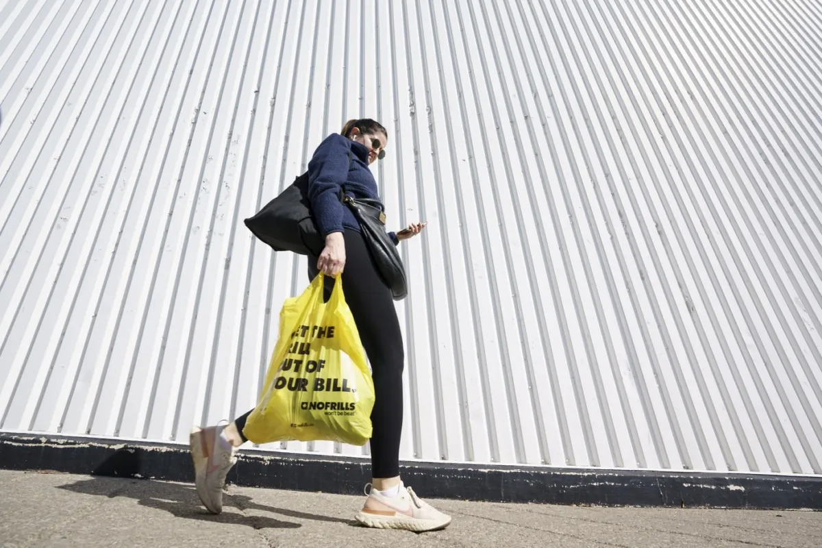 A person leaves a Toronto supermarket with groceries on Oct. 5, 2022. (The Canadian Press/Alex Lupul)
