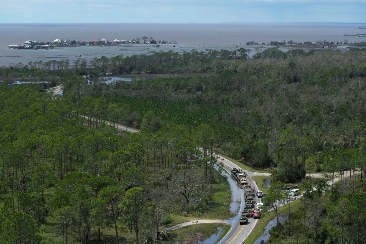 In this photo made in a flight provided by mediccorps.org, National Guardsmen and other first responders gather on a road leading to Keaton Beach and Dark Island, (back L ), near Fish Creek, Fla., following the passage of Hurricane Idalia, on Aug. 30, 2023. (Rebecca Blackwell/AP)
