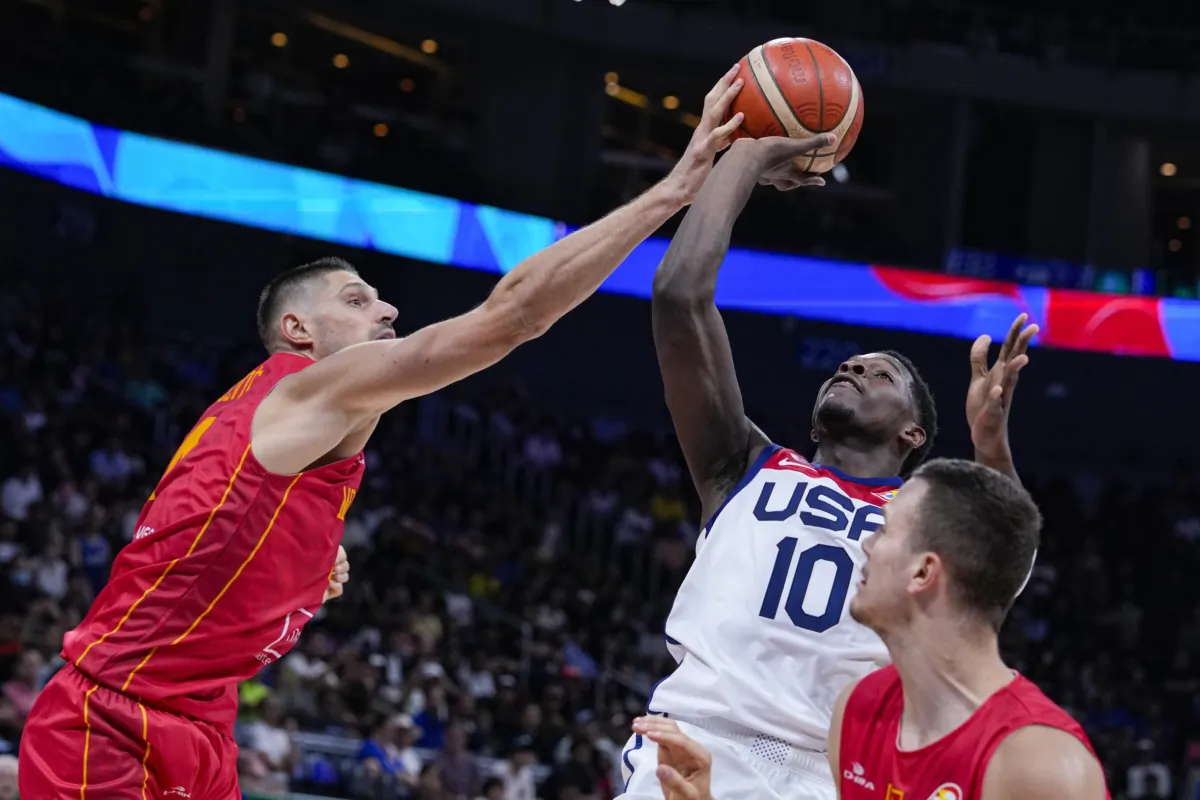 Montenegro center Nikola Vucevic (4) blocks the shot of U.S. guard Anthony Edwards (10) during the second half of a Basketball World Cup second round match in Manila, Philippines, on Sept. 1, 2023. (Michael Conroy/AP Photo)