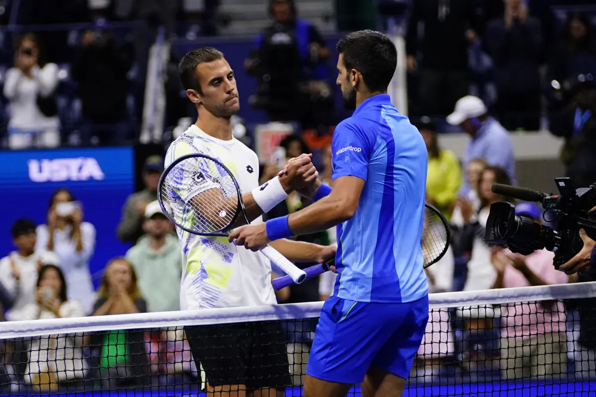Novak Djokovic, right, of Serbia, shakes hands with Laslo Djere, of Serbia, after winning their match during the third round of the U.S. Open tennis championships, in New York on Sept. 2, 2023. (Frank Franklin II/AP Photo)