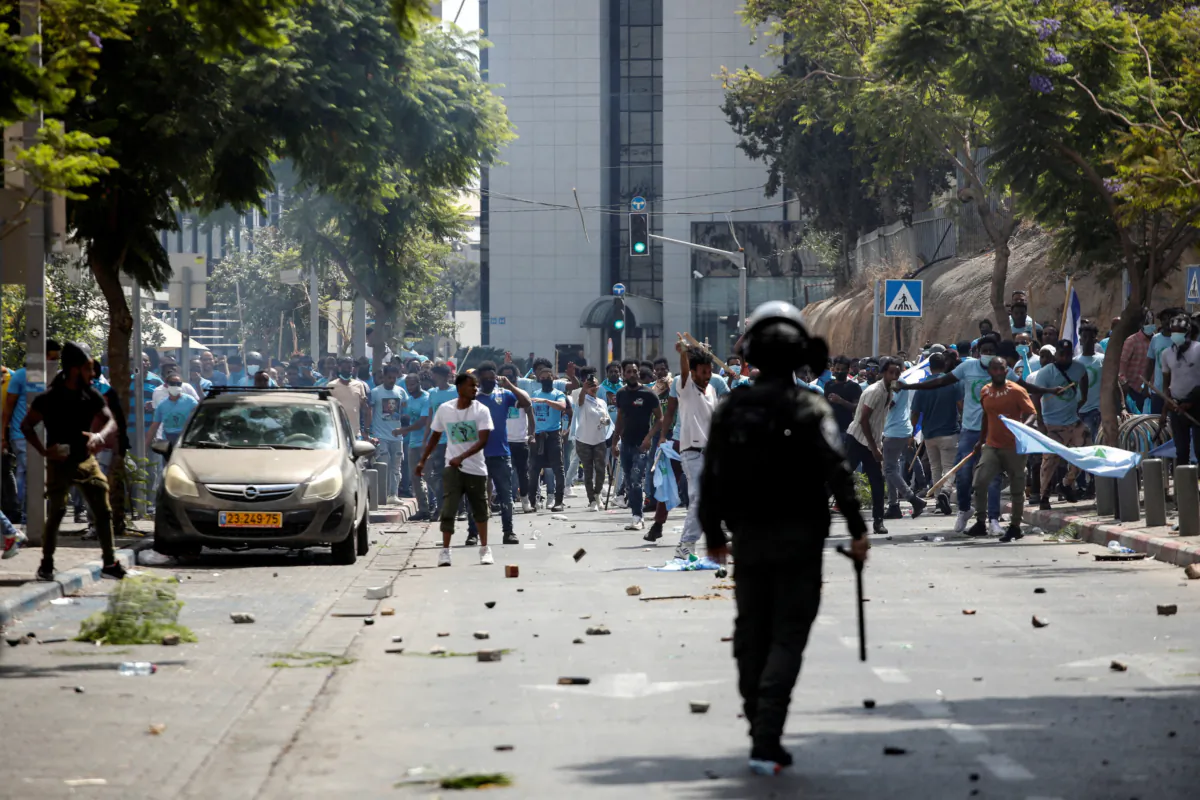 Protesters hold sticks and flags during violent demonstrations by Eritrean asylum seekers, including both supporters and opponents of the Eritrean government, in Tel Aviv, Israel, Sept. 2, 2023. (Moti Milrod/Reuters)
