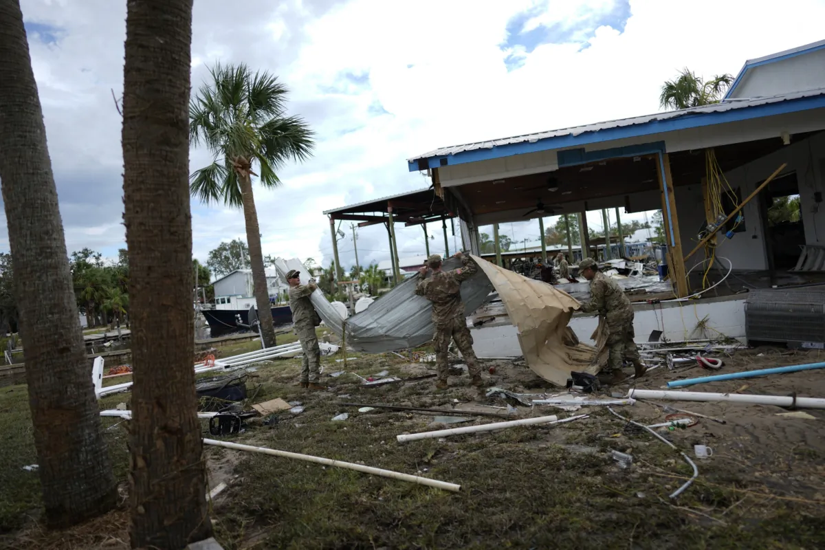 Members of the National Guard assist storm-damaged business The Marina with moving and piling debris, one day after the passage of Hurricane Idalia, in Horseshoe Beach, Fla., on Aug. 31, 2023. (Rebecca Blackwell/AP Photo)