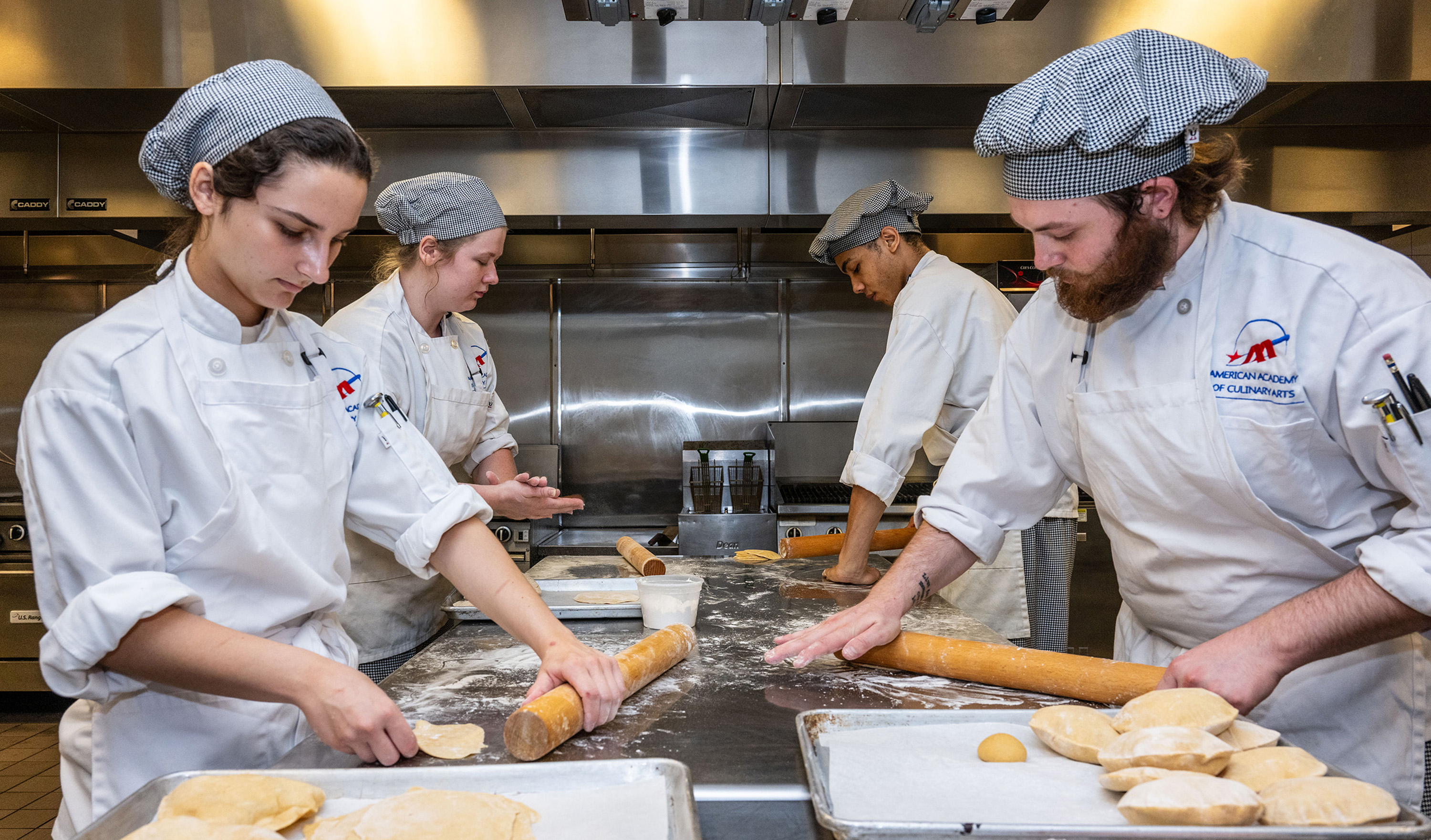 From left, Savannah Kopyar, Cassandra Kagle, Josiah Idley and Hunter Bierly, all culinary students from Pittsburgh Technical College, roll dough to make chapati bread on Monday, July 24, 2023.