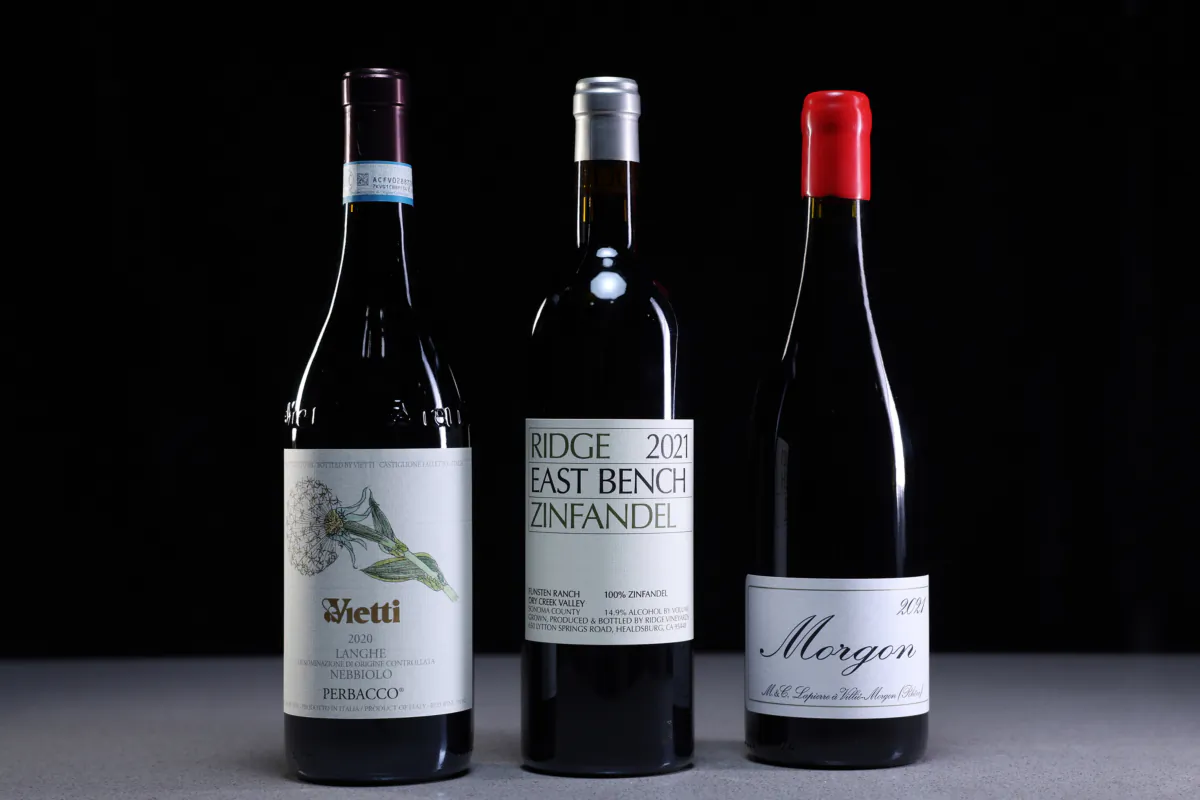 A selection of red wines that are good to drink during hot summer weather are seen in a Chicago Tribune photo studio on Thursday, Aug. 17, 2023. From left, Vietti Langhe Nebbiolo Doc Perbacco 2020, Ridge East Bench Zinfandel 2021, Morgon 2021. (Terrence Antonio James/Chicago Tribune/TNS)
