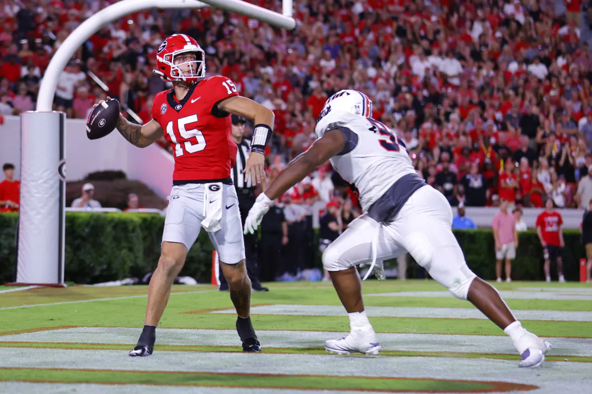 Carson Beck (15) of the Georgia Bulldogs is pressured by Christian Dowell (94) of the Tennessee Martin Skyhawks during the third quarter at Sanford Stadium  in Athens, Georgia, on Sept. 2, 2023. (Todd Kirkland/Getty Images)