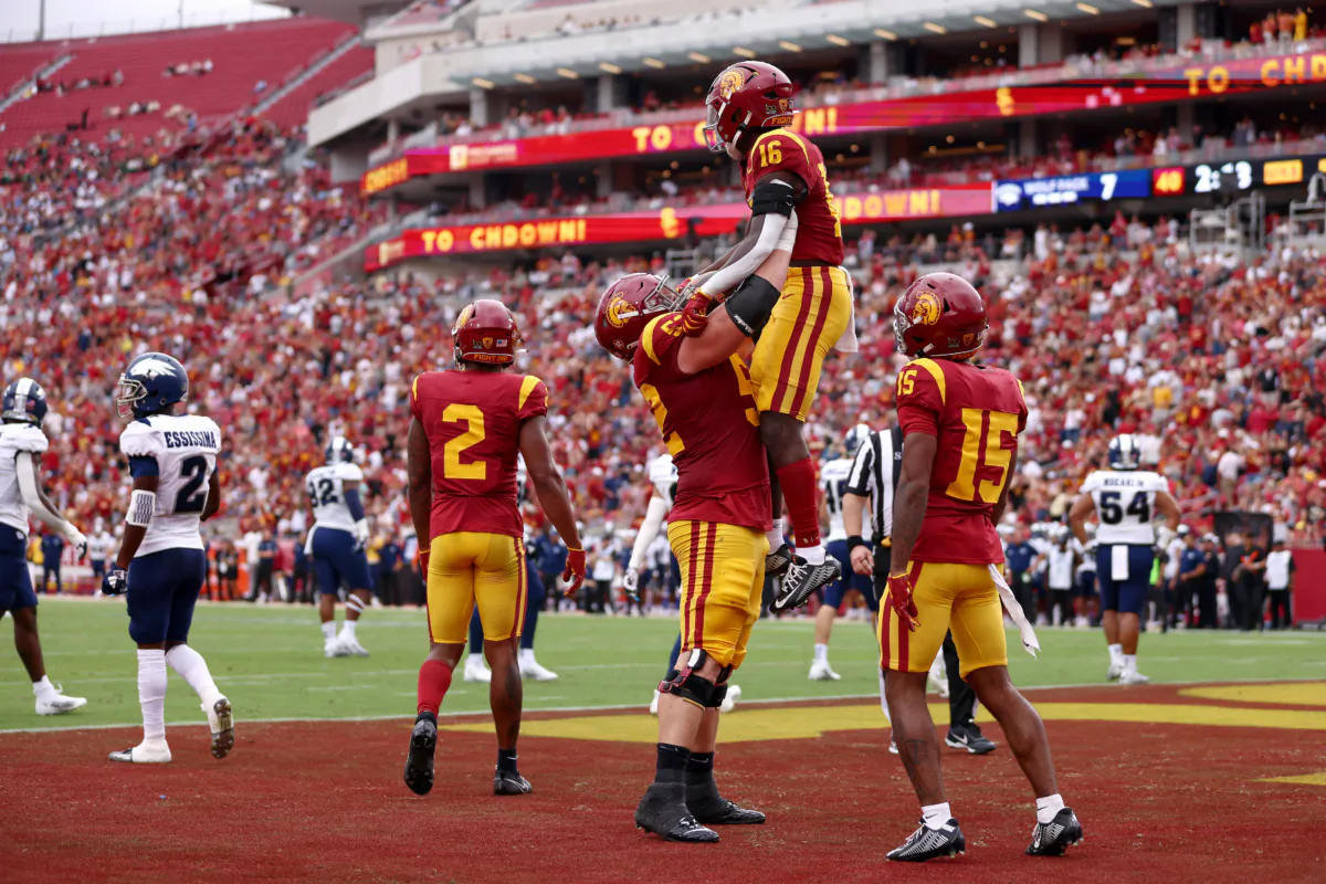 Tahj Washington (16) of the USC Trojans celebrates his touchdown with teammates Jarrett Kingston (52) and Dorian Singer (15) during the first quarter against the Nevada Wolf Pack at United Airlines Field at the Los Angeles Memorial Coliseum in Los Angeles on Sept. 2, 2023. (Katelyn Mulcahy/Getty Images)