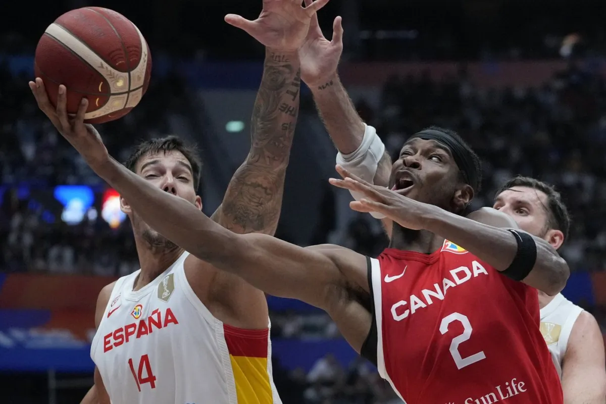 Canada guard Shai Gilgeous-Alexander (2) shoots against Spain centre Willy Hernangomez (14) during the Basketball World Cup second round match between Spain and Canada at the Indonesia Arena stadium in Jakarta, Indonesia, on Sept. 3, 2023. (The Canadian Press/AP/Achmad Ibrahim)