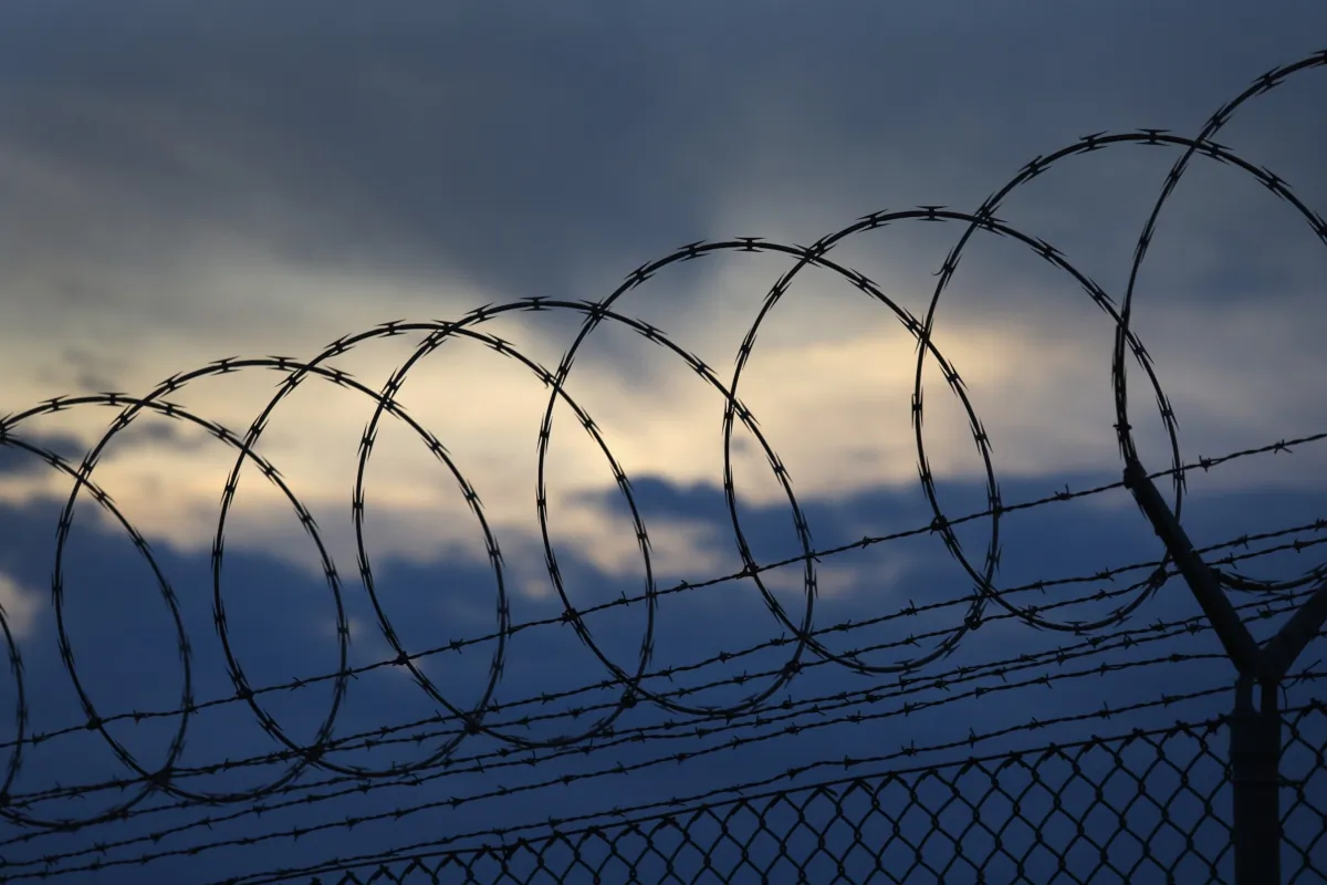 Razor wire tops a fence at a U.S. prison, on Oct. 22, 2016 at the U.S. Naval Station at Guantanamo Bay, Cuba. The U.S. military's Joint Task Force Guantanamo is holding 60 detainees at the prison, down from a previous total of 780. In 2008 President Obama issued an executive order to close the prison, which has failed because of political opposition in the U.S.  (John Moore/Getty Images)