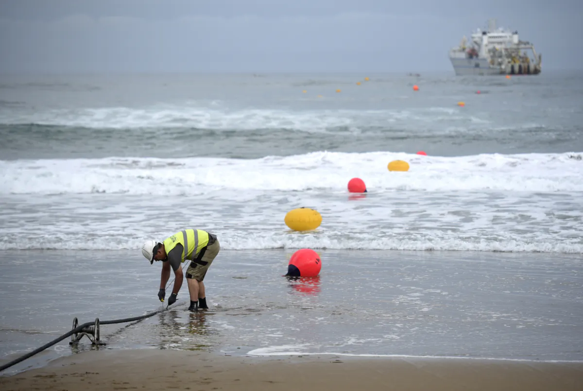 An operator works during the mooring of an undersea fiber optic cable near Sopelana, Spain, on June 13, 2017.
(Ander Gillenea/AFP via Getty Images)