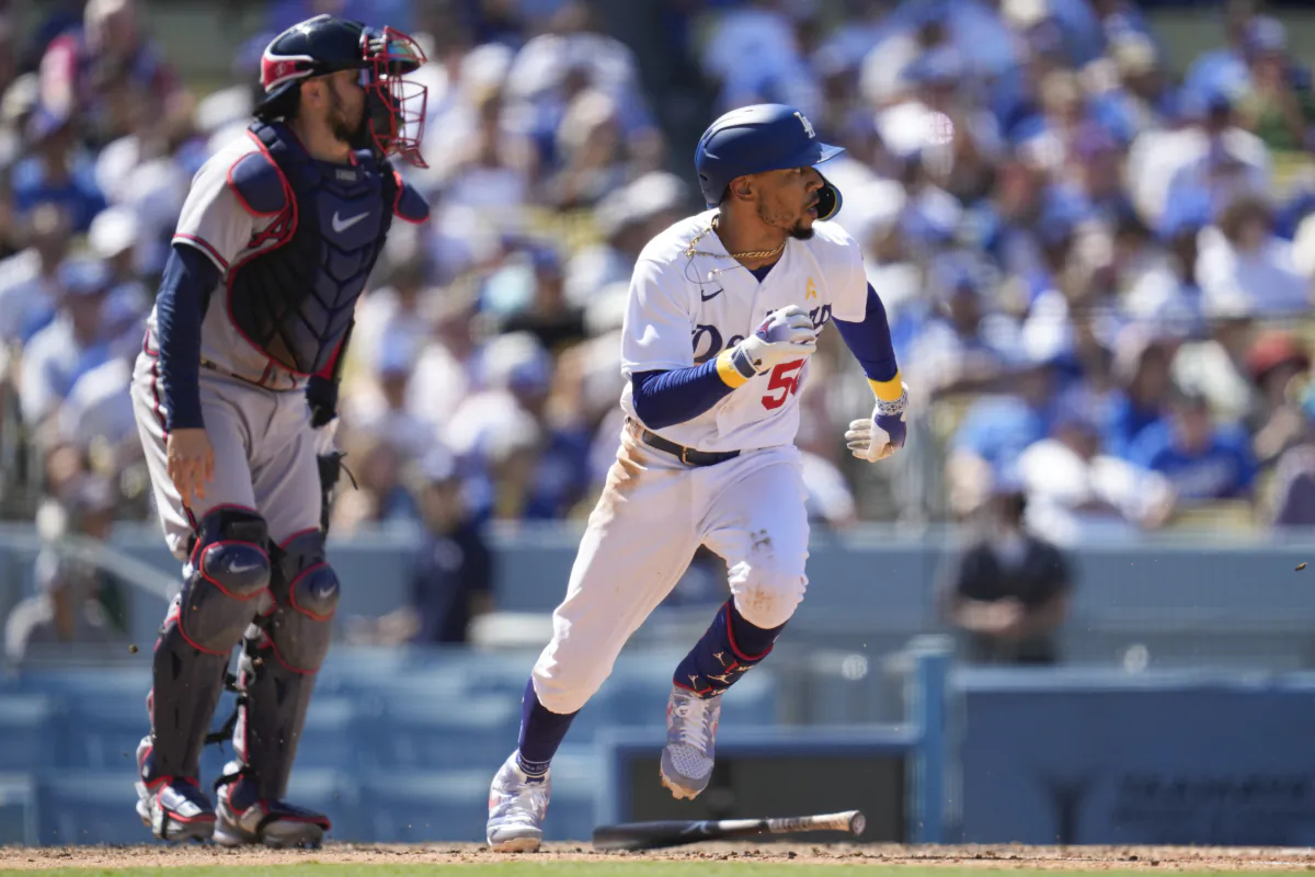 Los Angeles Dodgers' Mookie Betts (50) singles during the fifth inning of a baseball game against the Atlanta Braves, Miguel Rojas scored, in Los Angeles, on Sept. 3, 2023. (Ashley Landis/AP Photo)  