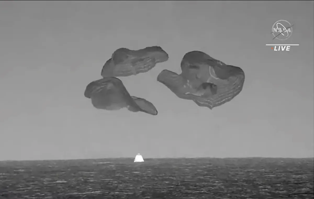 A SpaceX capsule, slowed by parachutes, splashes down in the Atlantic Ocean off the Florida coast on Sept. 4, 2023, as it returns to Earth with NASA astronaut Stephen Bowen, United Arab Emirates astronaut Sultan al-Neyadi, NASA astronaut Warren (Woody) Hoburg and Roscosmos cosmonaut Andrei Fedyaev after a six-month stay at the International Space Station. (NASA via AP)