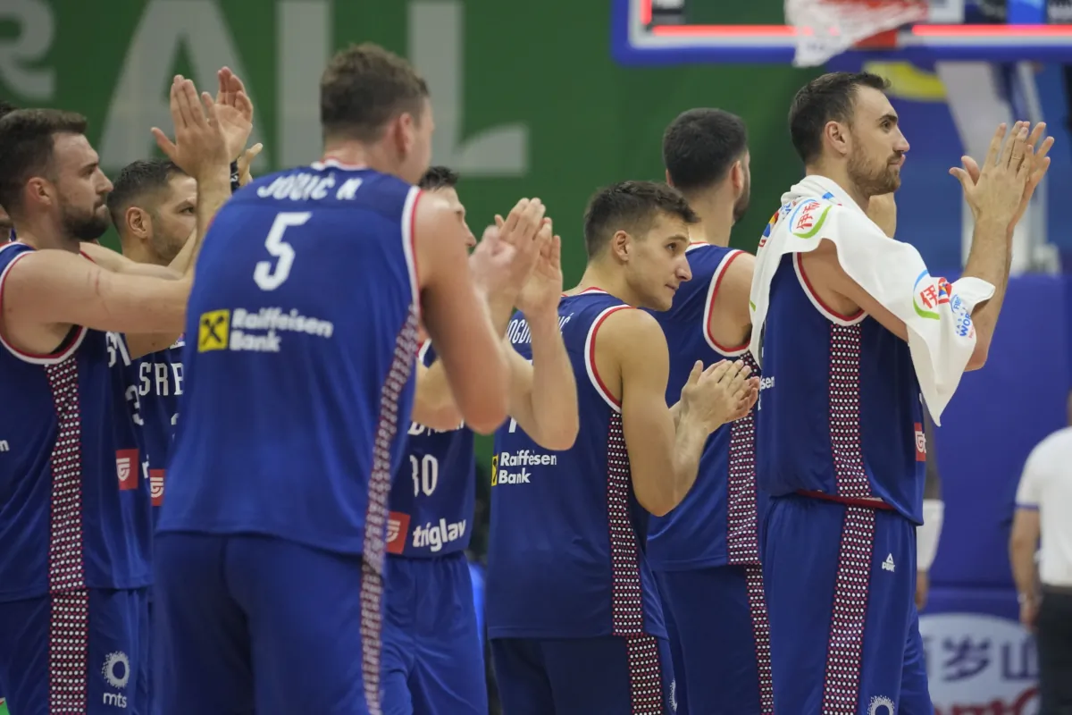 Serbia team celebrate after winning against Dominican Republic during their Basketball World Cup second round match at the Araneta Coliseum in Manila, Philippines, on Sept. 3, 2023. (Aaron Favila/AP Photo)