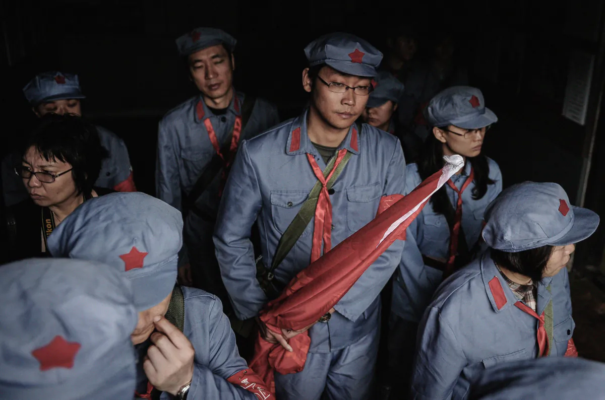 Visitors dressed in red army uniforms visiting a house where former Chinese leader Mao Zedong used to stay, during an educational tour in Jinggangshan, China, on Sept. 21, 2012. (Peter Parks/AFP/Getty Images)