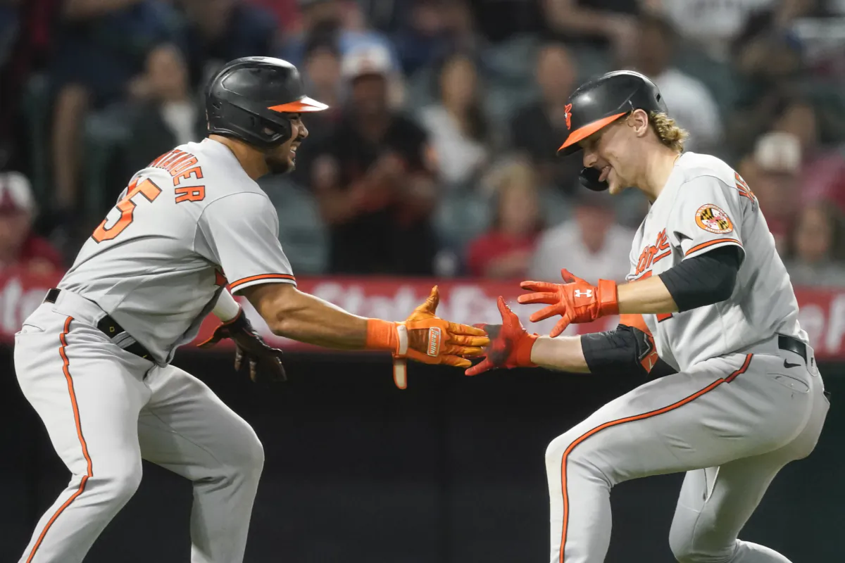 Baltimore Orioles' Gunnar Henderson, right, celebrates after his three-run home run with designated hitter Anthony Santander, left, who also scored along with Ryan Mountcastle, during the seventh inning of a baseball game against the Los Angeles Angels, in Anaheim, Calif., on Sept. 4, 2023 (Ryan Sun/AP Photo)